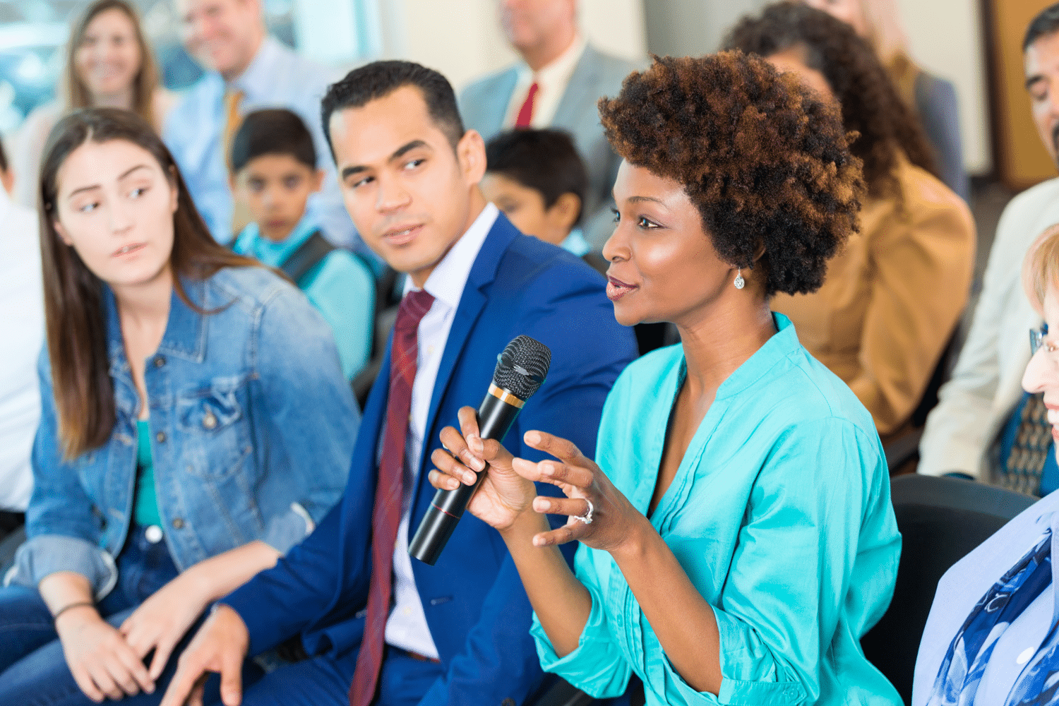 Woman at a meeting asking questions